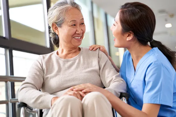 車椅子の女性と介護士が話をしている様子